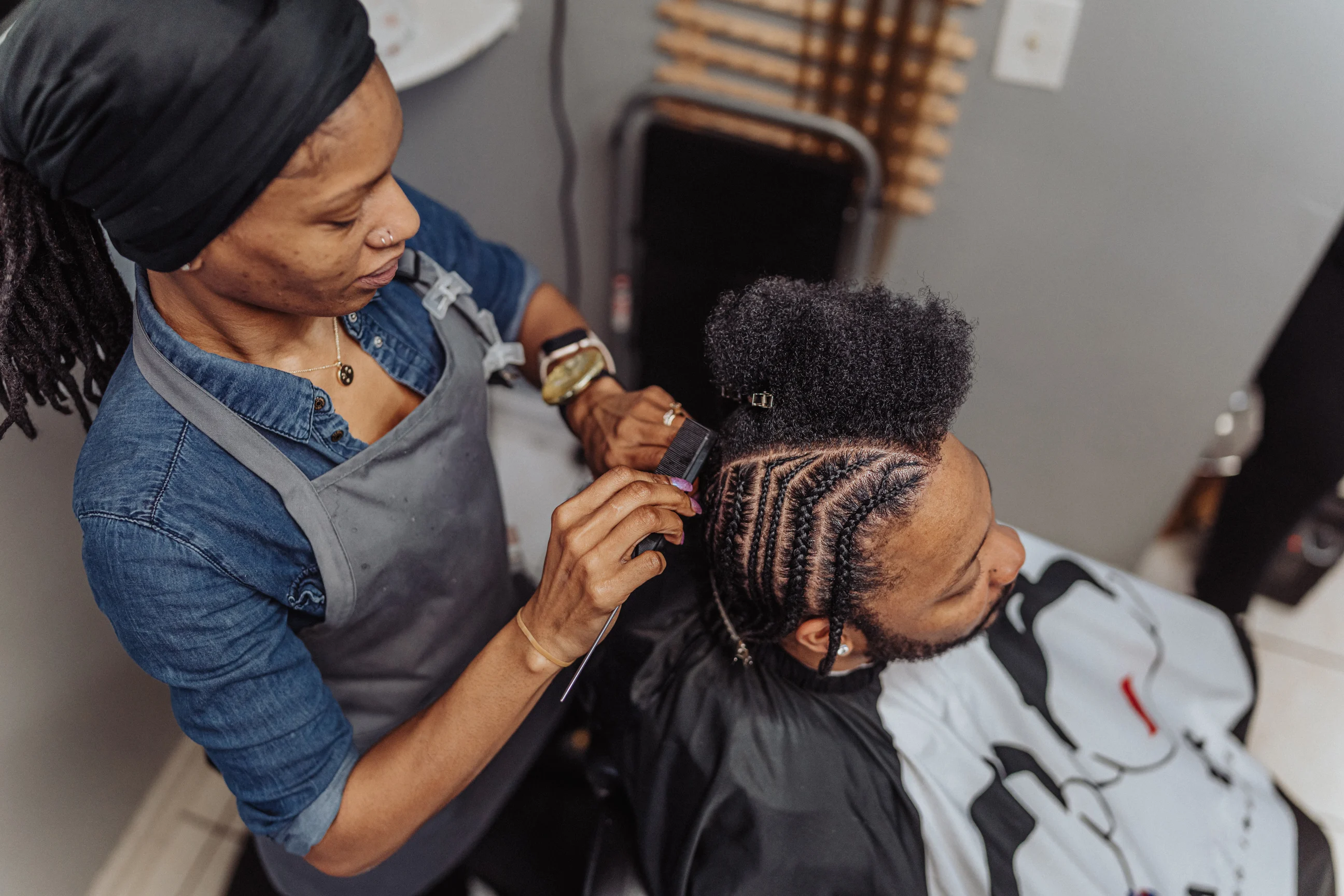 African American man having his hair braided